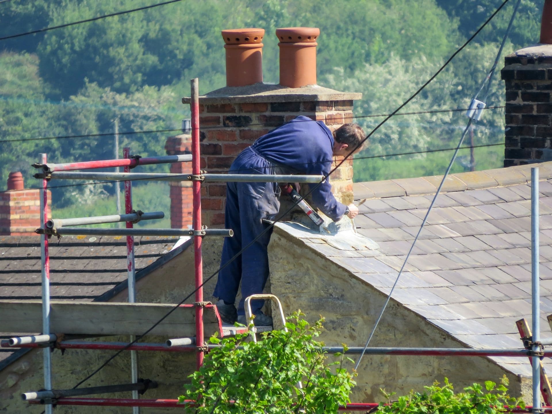 roofer repairing flashing on chimney